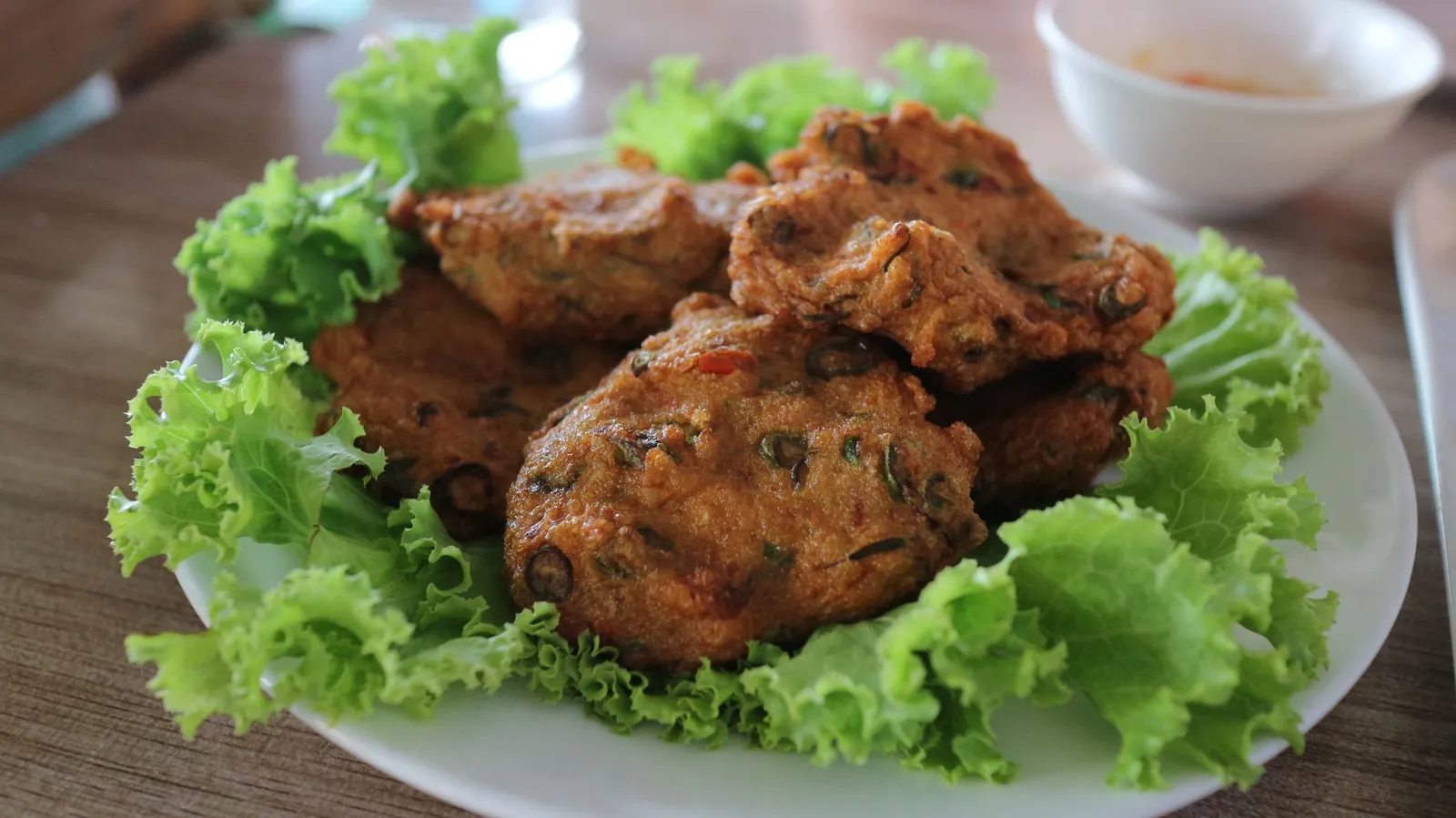 Đĩa bánh cuốn tráng mỏng rắc hành phi ăn kèm chả mực giã tay vàng ruộm và bát nước mắm chua ngọt